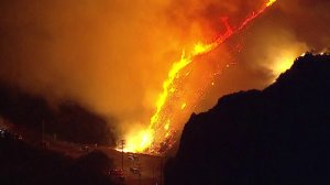 The Woolsey Fire is seen burning through a canyon area in L.A. County on Nov. 11, 2018. The fire had killed two people in Malibu by that time. (Credit: KTLA)