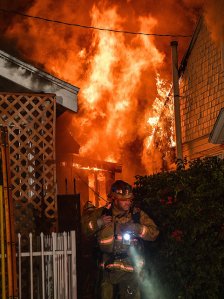 An LAFD firefighter on scene at a house fire in the Vermont Square neighborhood of Los Angeles on Dec. 23, 2018. (Credit: Tod Sudmeier/ LAFD)