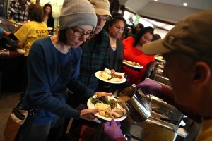 Camp Fire evacuees wait in line to receive a free Thanksgiving meal at Sierra Nevada Brewery on Nov. 22, 2018, in Chico. (Credit: Justin Sullivan/Getty Images)