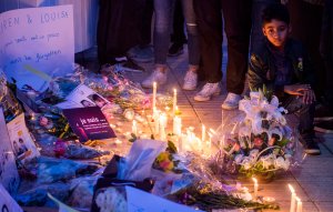 A Moroccan boy looks at candles and flowers during a vigil for the two Scandinavian hikers who were killed in Morocco, outside the Danish Embassy in Rabat on Dec. 22, 2018. (Credit: Fadel Senna/AFP/Getty Images)