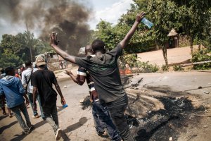 Protesters walk near the electoral commission in Beni during a demonstration against the postponement of elections in the territory of the Beni and the city of Butembo on Dec. 27, 2018. (Credit: ALEXIS HUGUET/AFP/Getty Images)