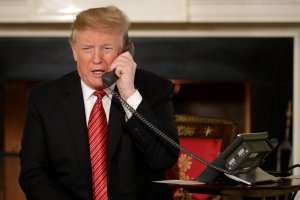 U.S. President Donald Trump takes phone calls from children as he participates in tracking Santa Claus' movements with the North American Aerospace Defense Command (NORAD) Santa Tracker on Christmas Eve in the East Room of the White House Dec. 24, 2018, in Washington, D.C. (Credit: Chip Somodevilla/Getty Images)