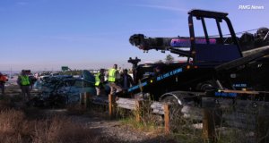 A still from a video shows what appears to be a blue Toyota hatchback mangled in the rear on the side of the northbound 15 Freeway in Rancho Cucamonga on Dec. 9, 2018. (Credit: RMG News)