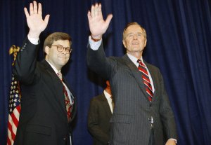 In this Nov. 26, 1991, file photo, President George H.W Bush, right, and William Barr wave after Barr was sworn in as the new Attorney General of the United States at a Justice Department ceremony in Washington. (Credit: Scott Applewhite / AP via CNN)