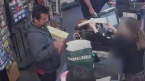 A man suspected of a vehicle burglary in West L.A. is seen making purchases in this still from surveillance video released by LAPD on Jan. 22, 2019.