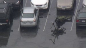 A bomb squad technician examines a car in a parking lot at Citrus College in Glendora on Jan. 15, 2019.