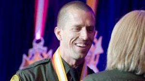 In 2014, Orange County Sheriff's Deputy Michael Higgins shakes hands with Sheriff Sandra Hutchens as he accepts the Medal of Valor in Irvine. (Credit: Orange County Register)