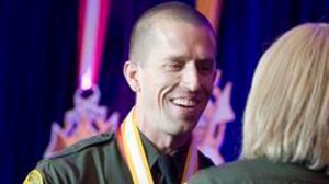 In 2014, Orange County Sheriff's Deputy Michael Higgins shakes hands with Sheriff Sandra Hutchens as he accepts the Medal of Valor in Irvine. (Credit: Orange County Register)