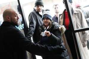 Furloughed federal workers show their IDs to enter a pop-up store of Kraft Heinz distributing free products on Jan. 17, 2019, in Washington D.C. (Credit: Alex Wong / Getty Images)