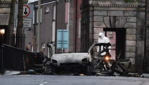 A forensic officer inspects the remains of the van used as a car bomb on an attack outside Derry Court House on January 20, 2019 in Londonderry, Northern Ireland. (Credit: Charles McQuillan/Getty Images)