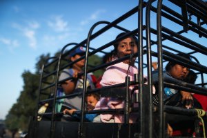 People from a caravan of Central American migrants wait to depart on a truck, whose driver offered a ride, on their way toward the United States, on Jan. 22, 2019 in Santo Domingo Zanatepec, Mexico. (Credit: Mario Tama / Getty Images)