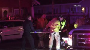 Rescuers treat a woman at the scene of a hit-and-run at 9th Street and Sierra Way in San Bernardino on Dec. 3, 2019. (Credit: On Scene News)