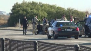 CHP officers pull a driver from a vehicle on the side of the 5 Freeway in the Camp Pendleton area after a lengthy pursuit and standoff on Jan. 3, 2019. (Credit: KTLA)
