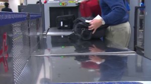 A passenger is seen going through security at Los Angeles International Airport on Jan. 8, 2019. (Credit: KTLA)