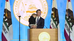 California Gov. Gavin Newsom is joined on stage by his 2-year-old son Dutch at his inaugural address on Jan. 7, 2019. (Credit: KTXL)