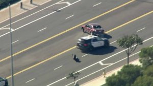 An LAPD cruiser attempts a PIT maneuver on a pursuit suspect on the Westside on Jan. 3, 2019. (Credit: KTLA)