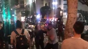 A still from video taken on Jan. 26, 2019 shows a man, later identified as Arka Oroojian, punching one of two women in downtown Los Angeles. (Credit: Mike Watson via Facebook)