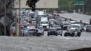 A car is seen stopped along the 101 Freeway in Calabasas after its driver led officers on a chase that ended in a crash there on Jan. 12, 2019. He was later killed in an officer-involved shooting. (Credit: LoudLabs)