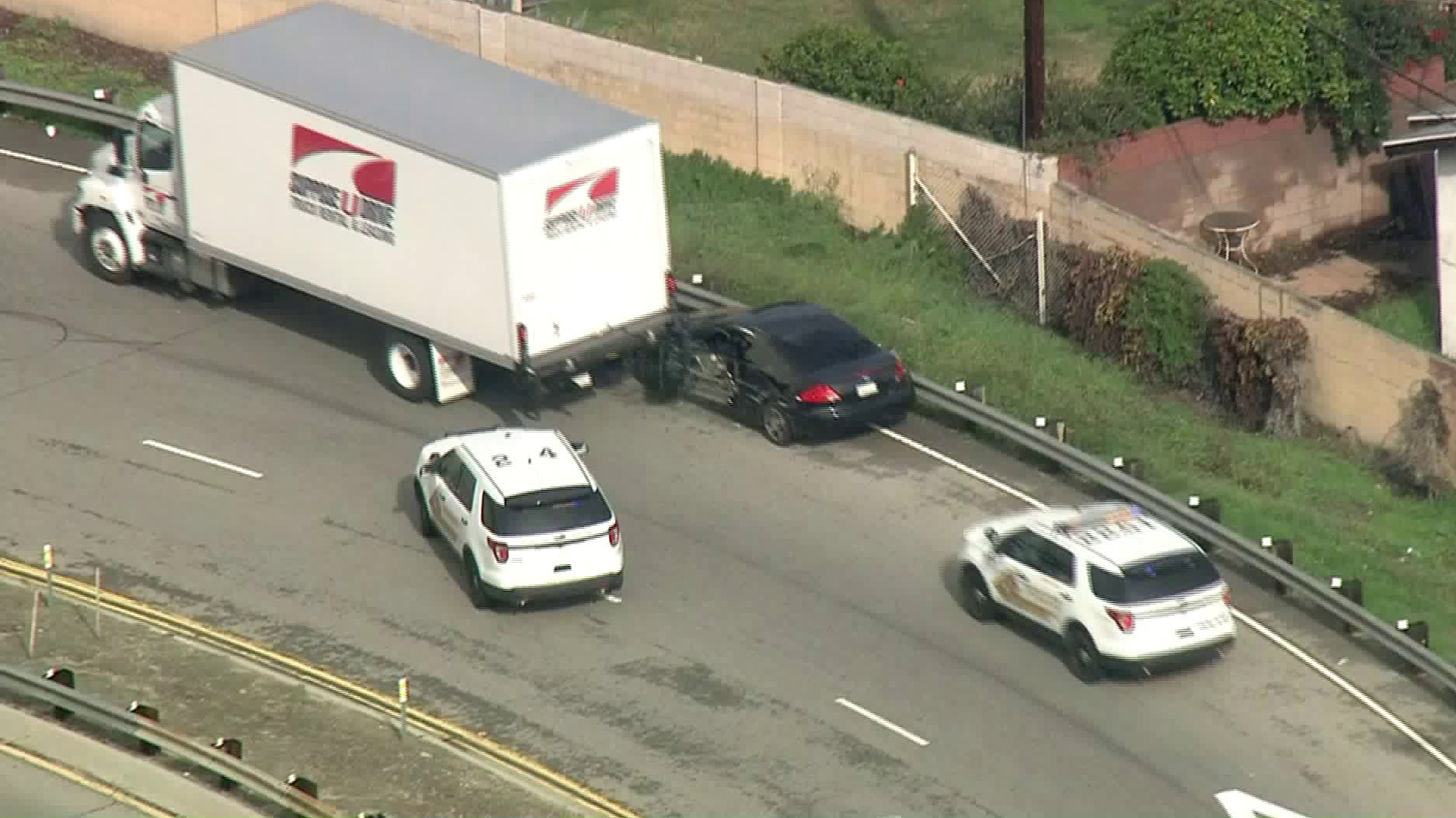The driver's side door of a car involved in a high-speed pursuit is torn off after being stuck next to a box truck in South El Monte on Jan. 18, 2019. (Credit KTLA)