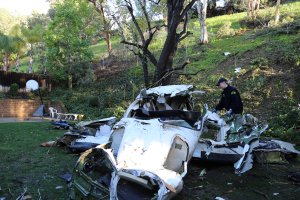 An National Transportation Safety Board official inspects the wreckage of a small plane that crashed into a Yorba Linda neighborhood, killing the pilot and four others, on Feb. 4, 2019, in an image released by the agency.