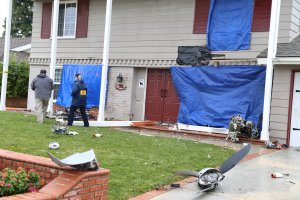 An National Transportation Safety Board official inspects the wreckage of a small plane that crashed into a Yorba Linda neighborhood, killing the pilot and four others, on Feb. 4, 2019, in an image released by the agency.