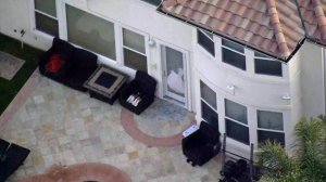 The back door of a Porter Ranch home where three people were found fatally shot appears shattered on Feb. 18, 2019. (Credit: KTLA)
