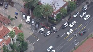 Several LAPD patrol cars are seen outside an apartment building at Franklin Avenue at North Gramercy Place after a lockdown a few blocks away at Sunset Bronson Studios on Feb. 14, 2018. (Credit: KTLA)