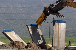 A border wall prototype is torn down at the U.S.-Mexico border, as seen from Tijuana on Feb. 27, 2019. (Credit: Guillermo Arias / AFP / Getty Images)