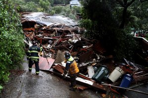 Southern Marin firefighters search a home that was swept down a hill by a mudslide in Sausalito during a rain storm on Feb. 14, 2019. (Credit: Justin Sullivan / Getty Images)