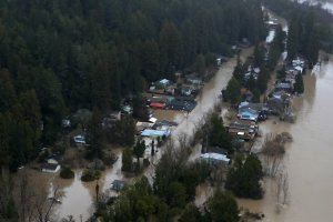 Homes sit under water in a flooded neighborhood in Guerneville, California, on Feb. 27, 2019. (Credit: Justin Sullivan / Getty Images)