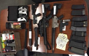 Firearms and counterfeit cash are seen in this photo from the Ventura County Sheriff's Office.