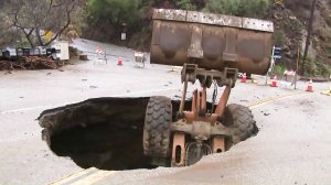 A front-loader fell into a hole on Yerba Buena Road on Feb. 2, 2019. (Credit: KTLA)