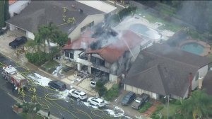 A house destroyed by flames is seen shortly after a small plane crash in Yorba Linda on Feb. 3, 2019. (Credit: KTLA)