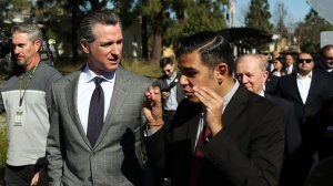 Gov. Gavin Newsom, center left, and Long Beach Mayor Robert Garcia, right, tour Century Villages at Cabrillo, an affordable housing development, on Feb. 19, 2019. (Credit: Dania Maxwell / Los Angeles Times)