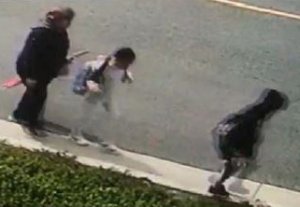 A woman is pictured in a surveillance camera image walking with her grandchildren before she was fatally struck by a hit-and-run driver in La Mirada on Feb. 20, 2019. (Credit: Los Angeles County Sheriff's Department)