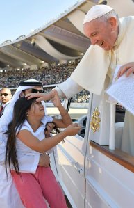 A little girl evaded tight police security inside Abu Dhabi's city stadium to run over and deliver a letter to Pope Francis on Feb. 6, 2019. (Credit: Vatican Media/REUTERS via CNN)