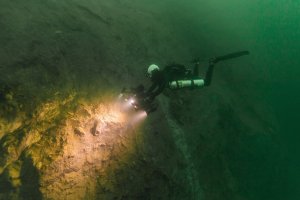 Divers look for fossils embedded in a cenote wall in Belize on Feb. 27, 2019. (Credit: Tony Rath/VOPA via CNN)