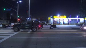 Police investigate the scene of a deadly shooting at Florence and Normandie avenues in South Los Angeles on Feb. 14, 2019. (Credit: KTLA)