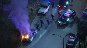 Police use a Taser to subdue a man following a pursuit that ended at Washington Boulevard and the 605 Freeway in Pico Rivera on March 15, 2019. (Credit: KTLA)
