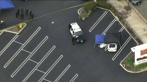 Police investigate the scene of a shooting that left a woman dead and a man wounded in the parking lot of a Big Lots store, 12550 Central Ave. in Chino, on March 21, 2019. (Credit: KTLA)