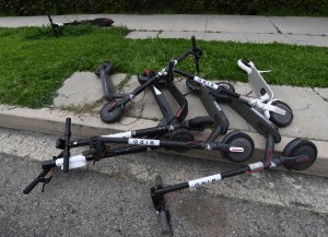 Shared electric scooters lie on a sidewalk in Los Angeles on Feb. 13, 2019. (Credit: Mark Ralston / AFP / Getty Images)