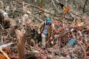 Joey Roush walks through debris March 4, 2019, at his mother's home after it was destroyed in a tornado in Beauregard, Alabama. (Credit: Tami Chappell / AFP / Getty Images)