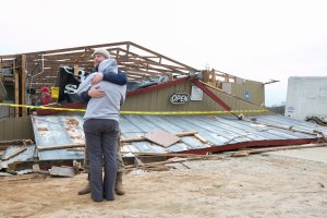 Gabe and Brandi O'Neal embrace outside of the Buck Wild Saloon after it was destroyed by a tornado on March 4, 2019, in Smith Station, Alabama.(Credit: Jessica McGowan/Getty Images)