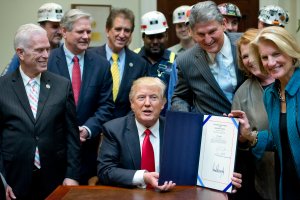 President Donald Trump signs H.J. Res. 38, disapproving the rule submitted by the U.S. Department of the Interior known as the Stream Protection Rule in the Roosevelt Room of the White House on February 16, 2017 in Washington, DC. (Credit: Ron Sachs-Pool/Getty Images)