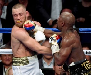 Floyd Mayweather Jr. hits Conor McGregor with a right in the 10th round of their super welterweight boxing match at T-Mobile Arena on August 26, 2017 in Las Vegas, Nevada. (Credit: Ethan Miller/Getty Images)