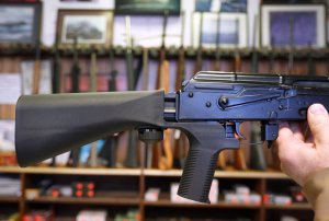 A bump stock device that fits on a semi-automatic rifle to increase the firing speed, making it similar to a fully automatic rifle, is installed on a AK-47 semi-automatic rifle at a gun store on October 5, 2017 in Salt Lake City, Utah. (Credit: George Frey/Getty Images)