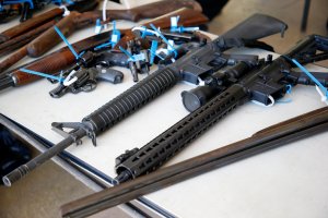 Two AR-15 rifles, along with other assorted guns, sit on a table after being surrendered during a City of Miami gun buy-back event in Miami, Florida on March 17, 2018. (Credit: RHONA WISE/AFP/Getty Images)