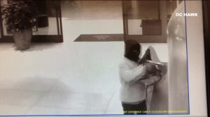 An armed robber is seen pointing a gun in a hotel in Irvine in this surveillance footage. (Credit: OC Hawk)