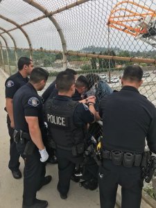Alhambra police officers and firefighters rescued a suicidal woman from an overpass of the 10 Freeway in Alhambra on April 20, 2019. (Credit: Alhambra Fire Department)