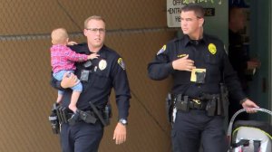 Parishioners and police tackled a woman who entered a Clairemont church service carrying a baby and a handgun on Easter Sunday. (Credit: KSWB via CNN Wire)
